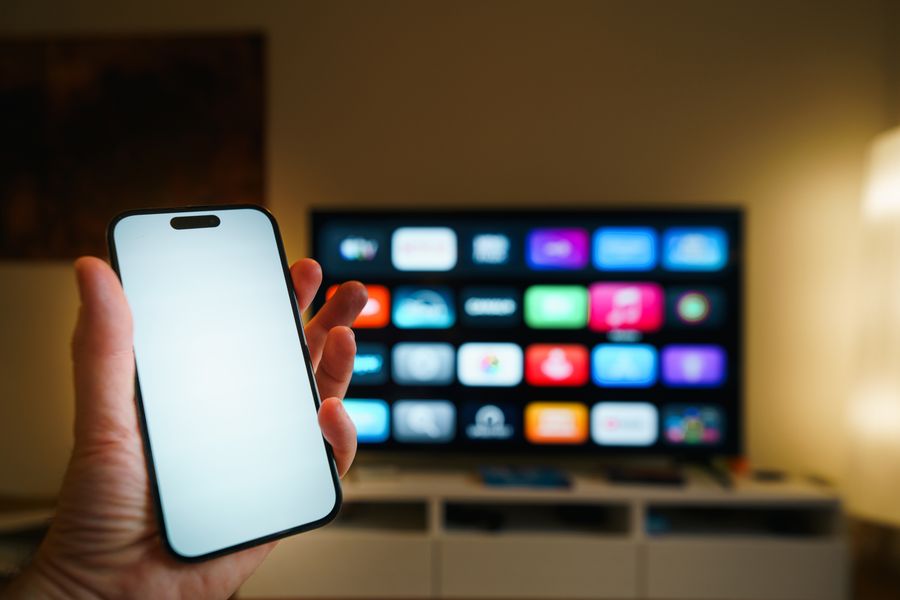 Smart TV showing an app grid next to a phone