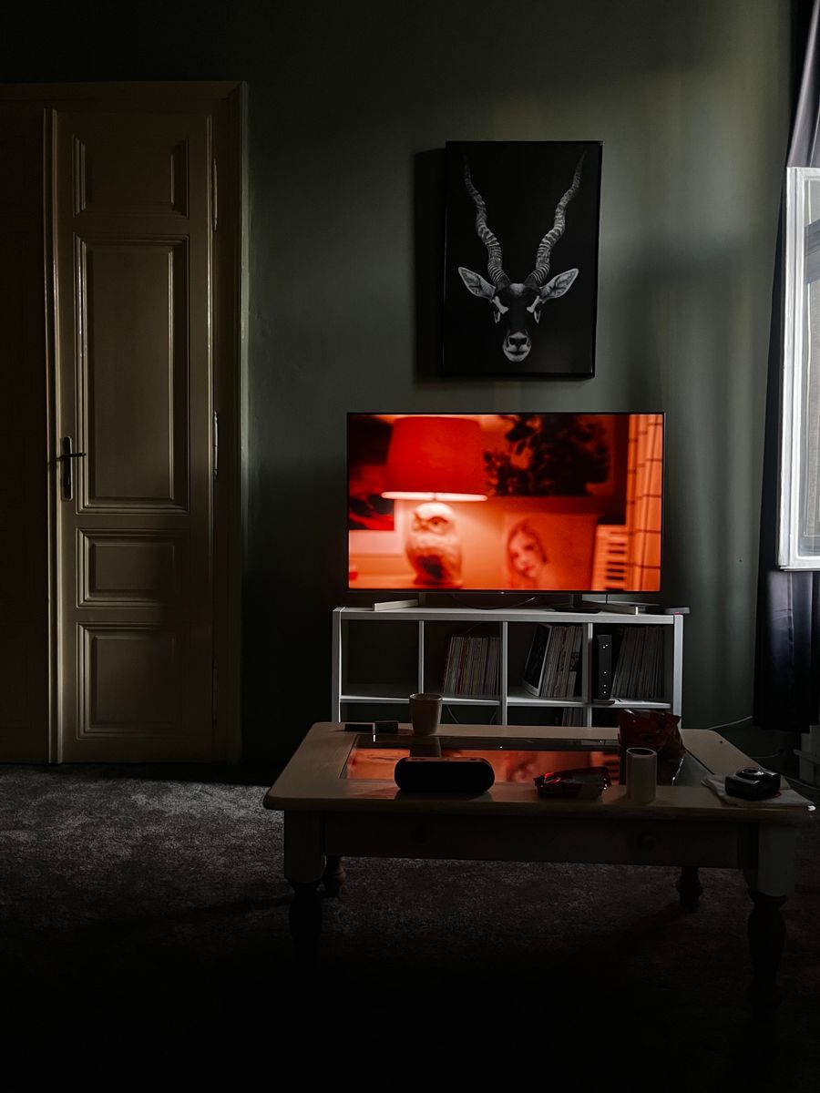 TV glowing in a dark living room